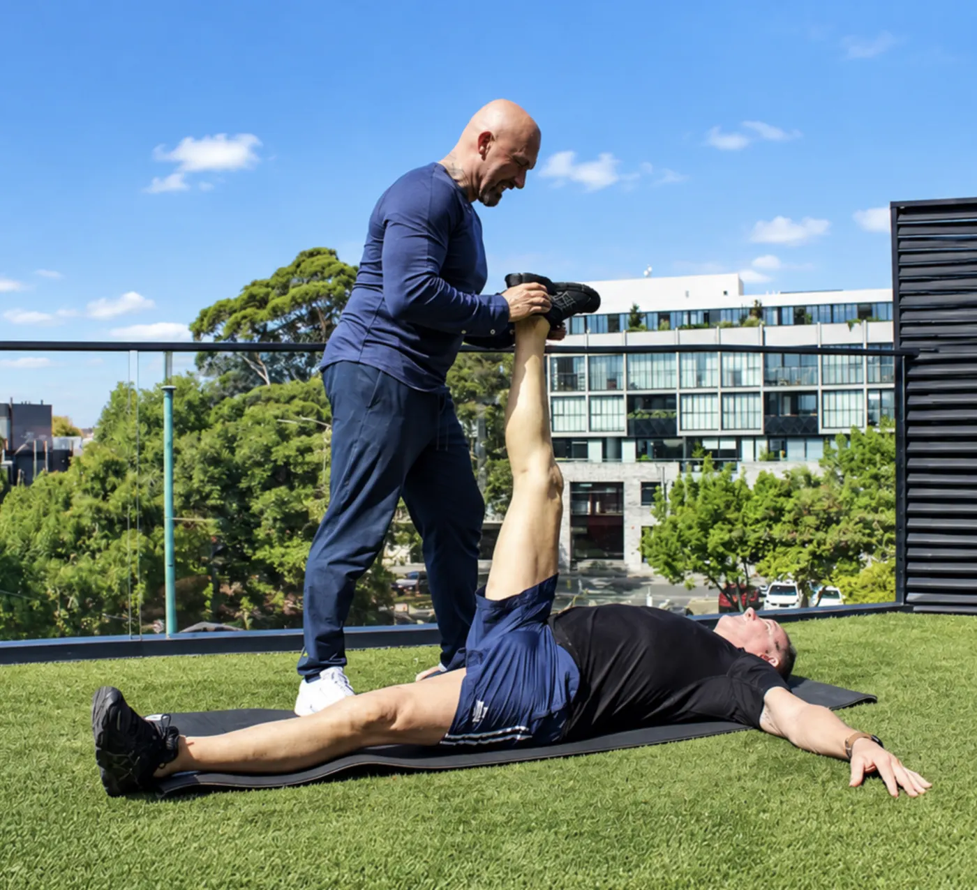 Grant helping a client with mobility and stretching